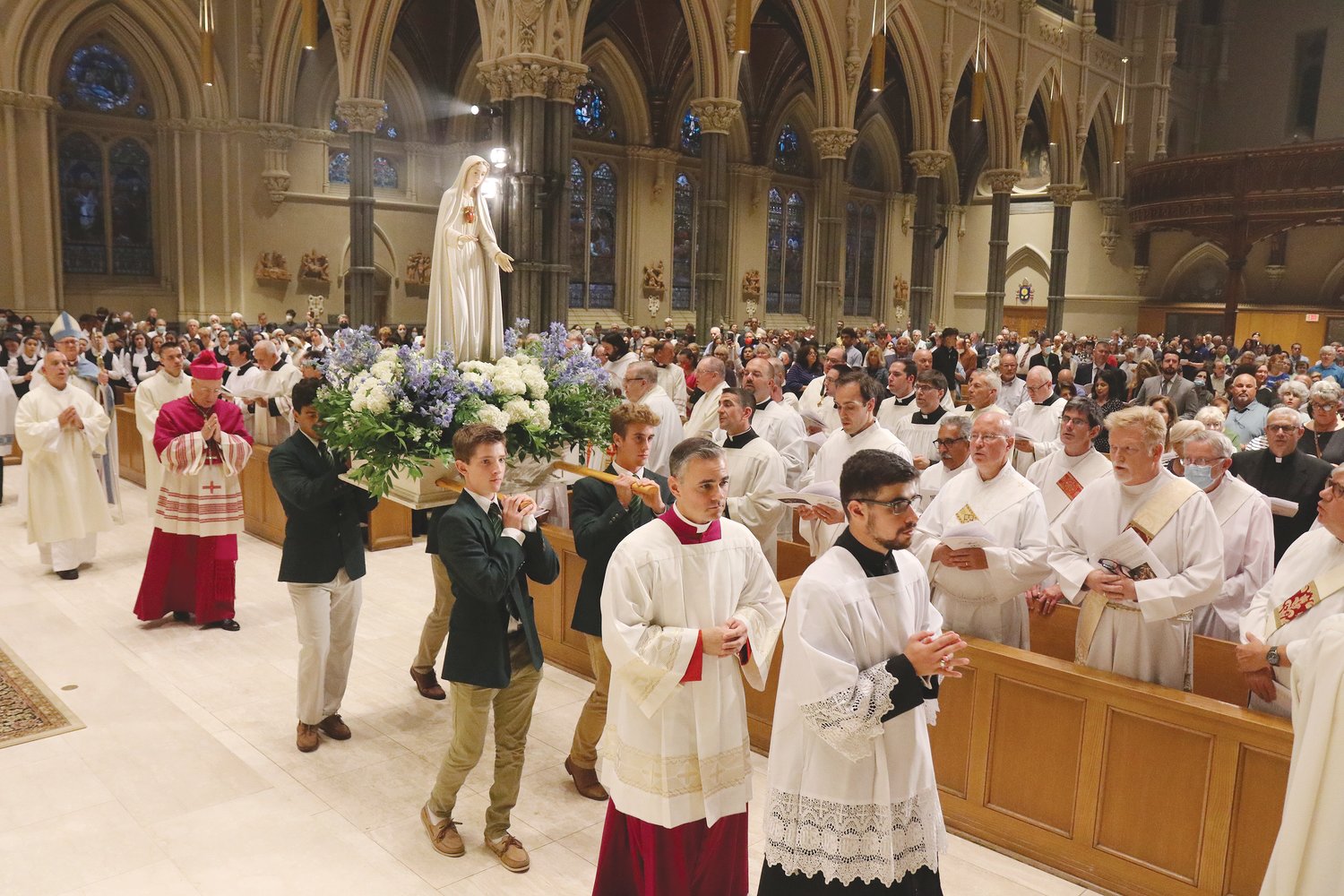 Bishop Hendricken students process around the cathedral with a statue of the Blessed Mother during A Night to Honor Mary, on Sept. 8.